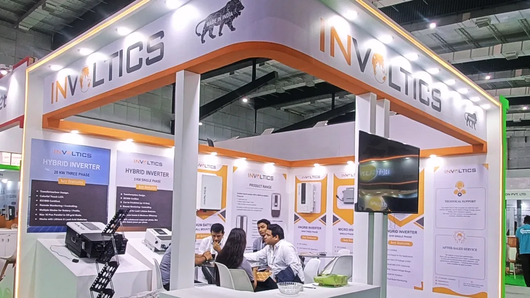 Custom exhibition stall with curved fascia and lighting, built by ADMUG Studio