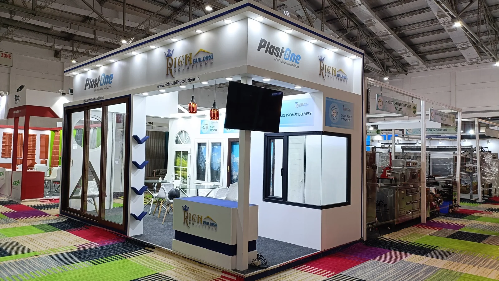 Corner exhibition stall designed and fabricated by ADMUG Studio for Rich Building Solutions and PlastOne