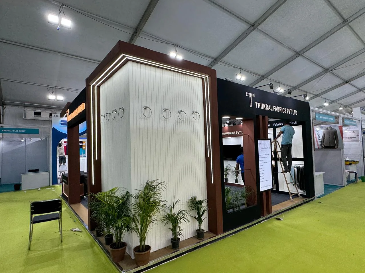 Corner exhibition stall designed and fabricated by ADMUG Studio for Thukral Fabrics